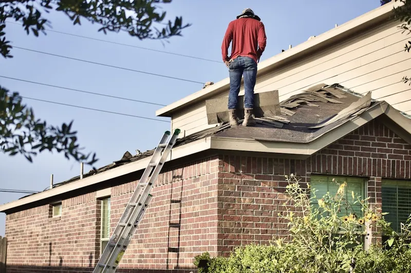 Professional roofer working on a residential roof in Wasco